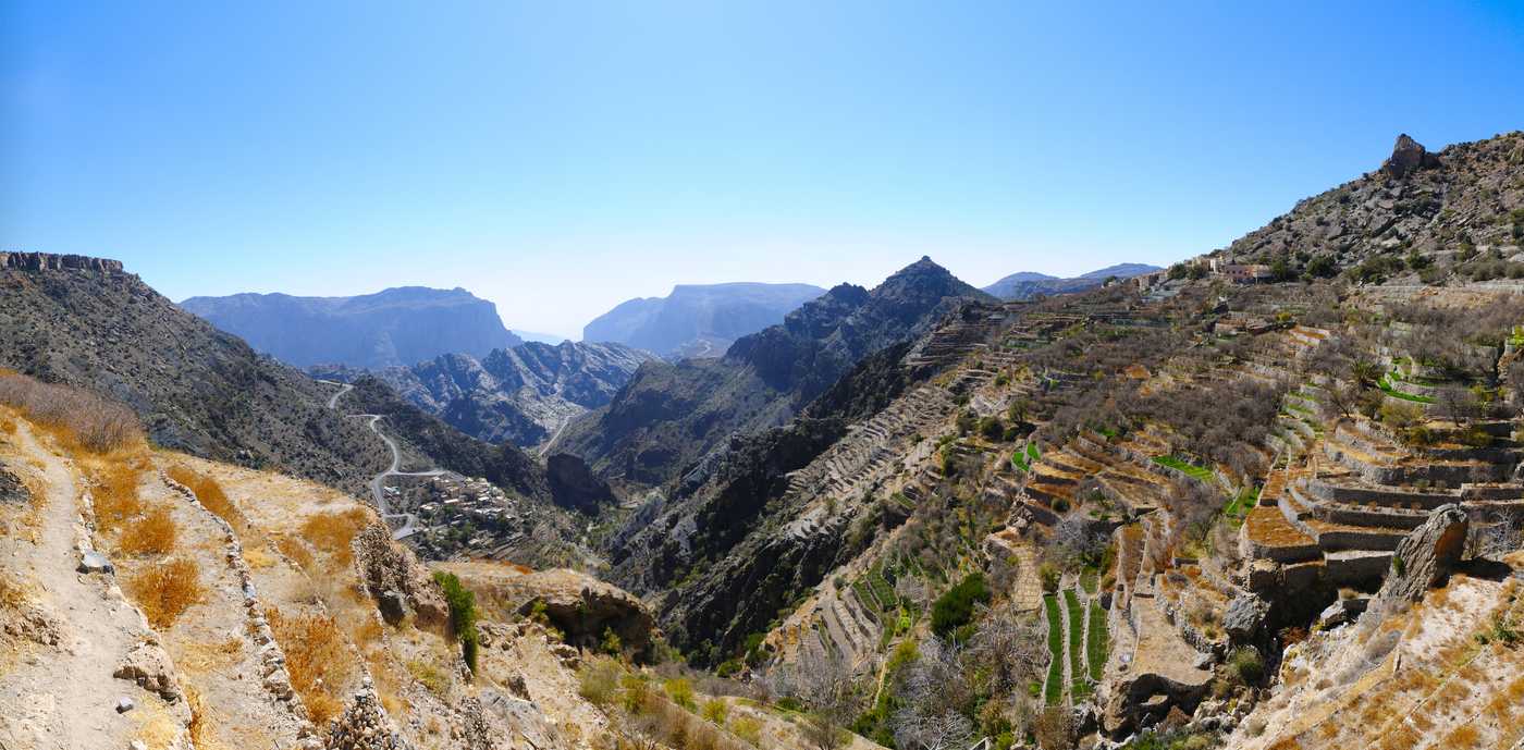 Terraced farms on the slopes of Jebel Akhdar, Oman, looking through a gap in the mountains