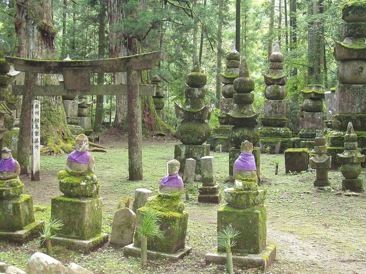 Moss-covered stone monuments under ancient cedars at Okunoin cemetery, Kōyasan.